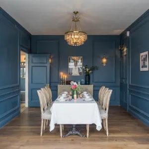 Elegant dining room with deep blue walls
